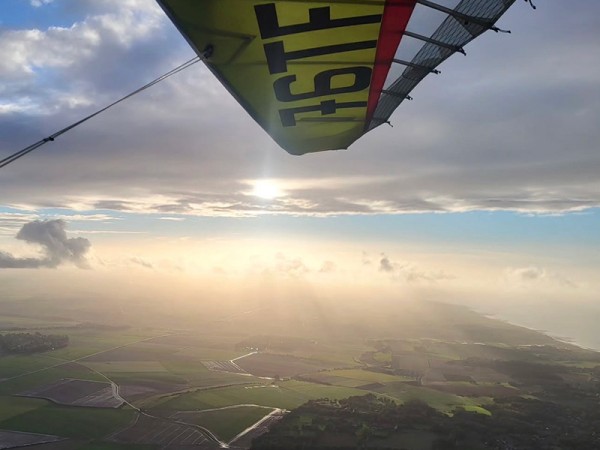 Vue depuis un ULM au-dessus de la campagne normande près de Dieppe, aile de l’appareil et lumière de fin de journée lors d’un baptême de l’air